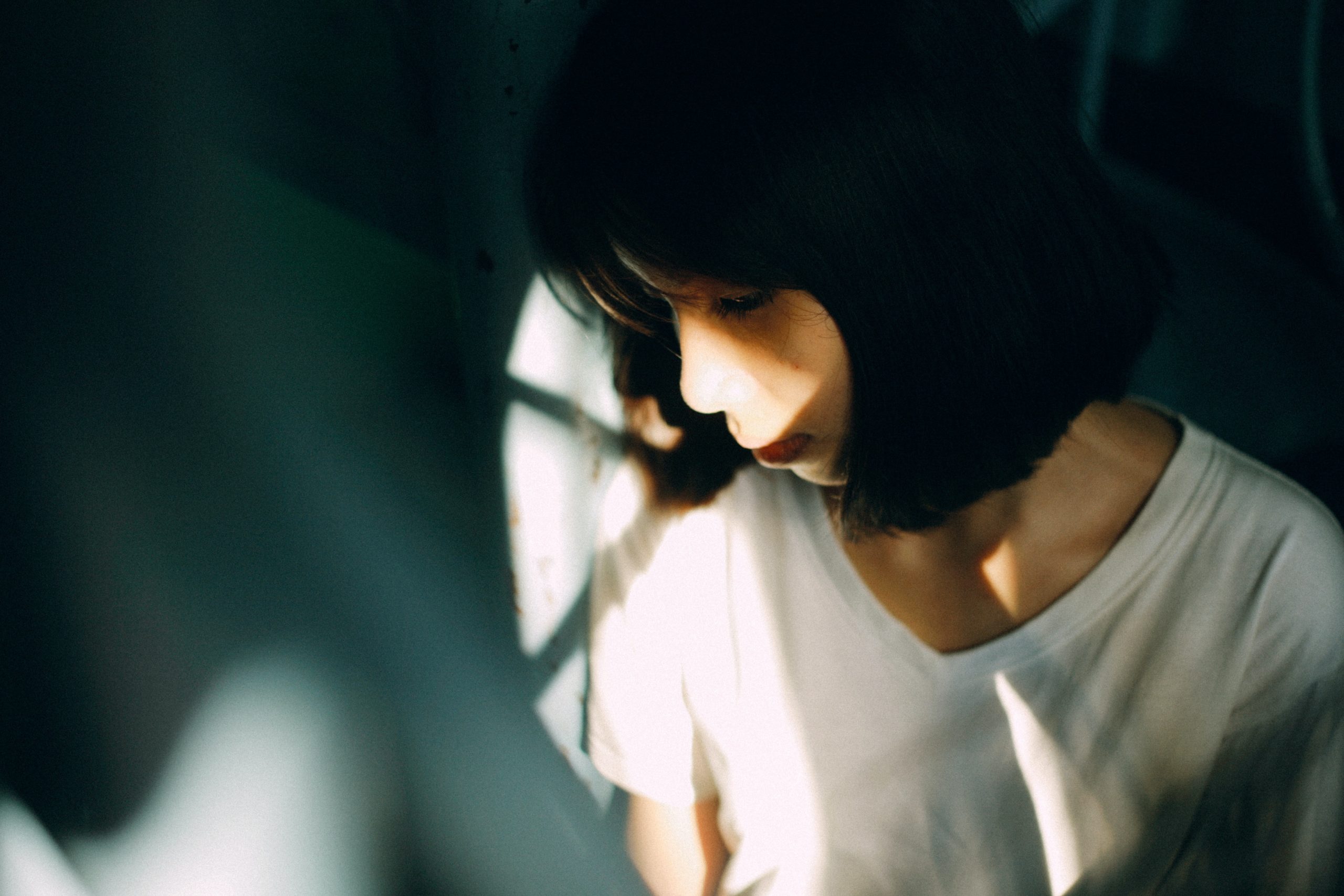 Woman looking sad and looking down at the ground