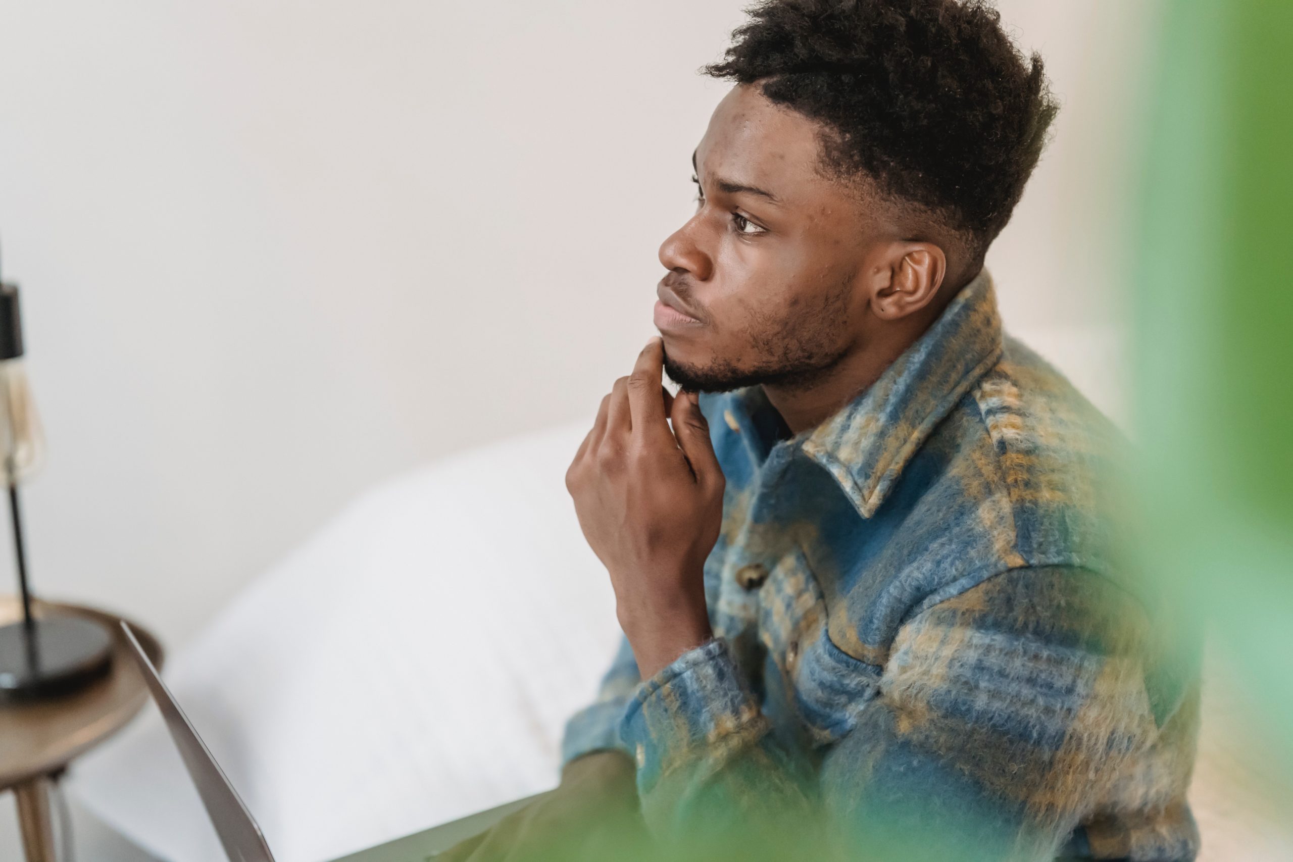 Man sitting on a chair looking deep in thought