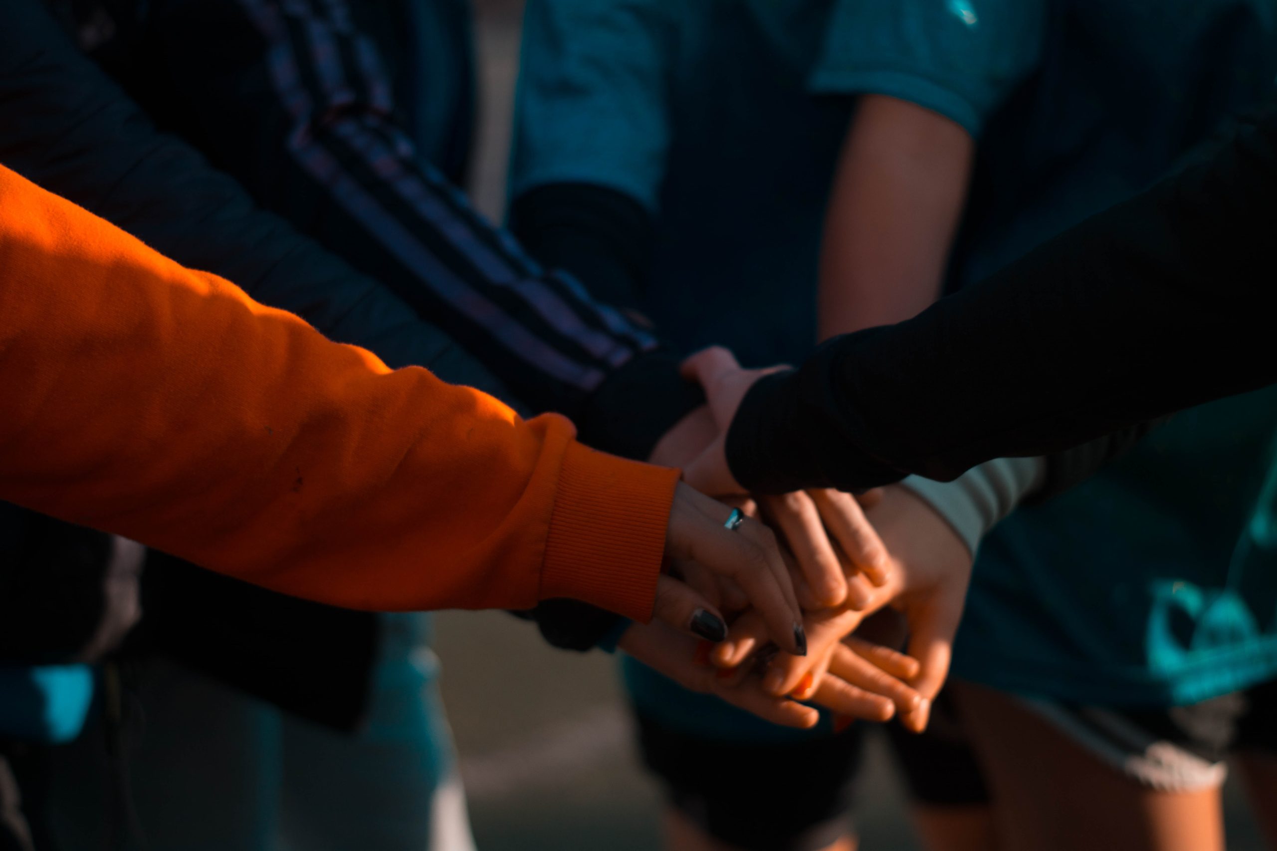 student hands intertwined with one another