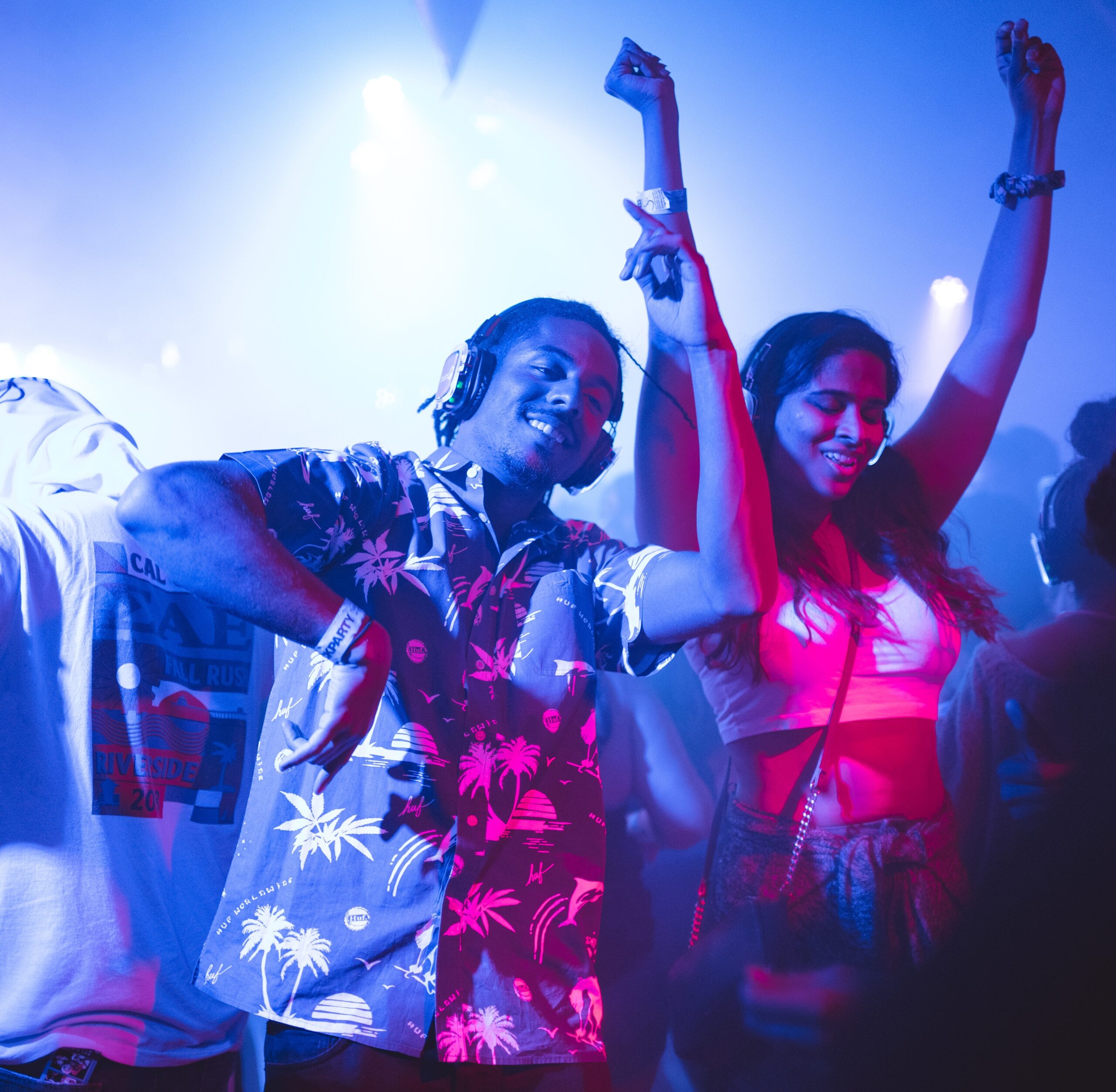 two young people at a party dancing with headphones on
