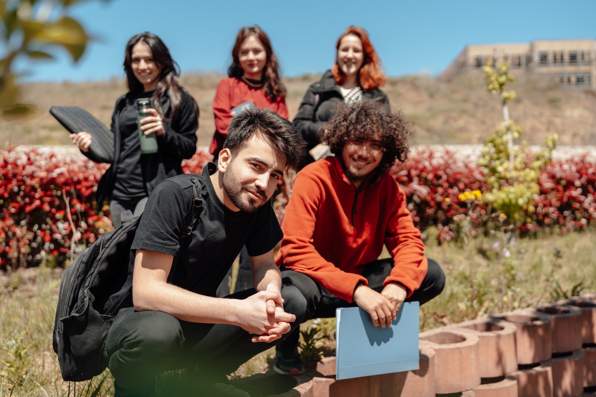 Group of college students connecting spending time outdoors together