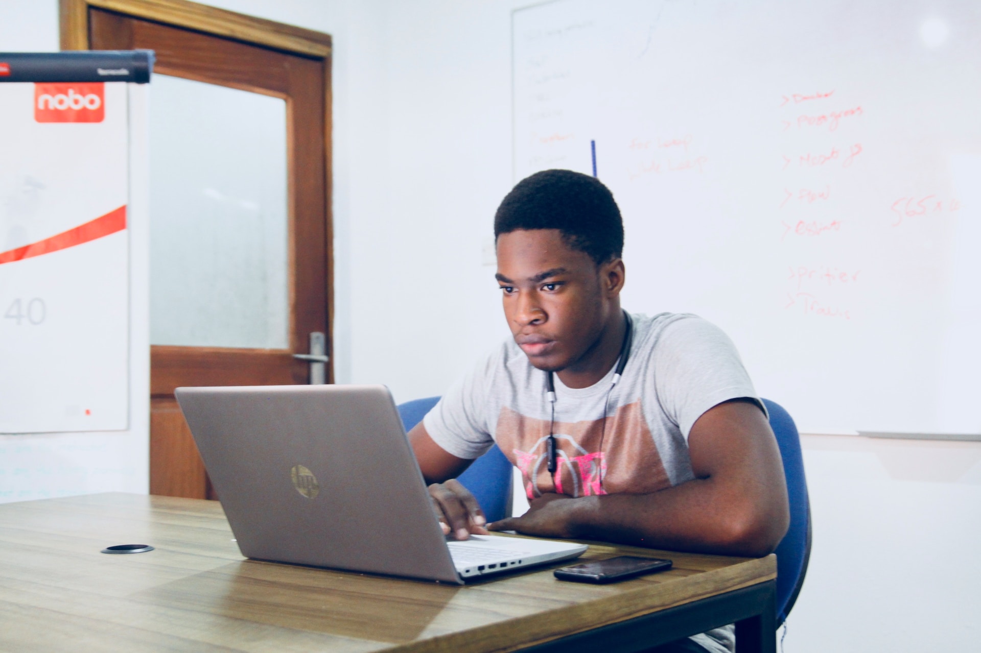 young person seated at a desk, with laptop open looking for reliable mental health websites