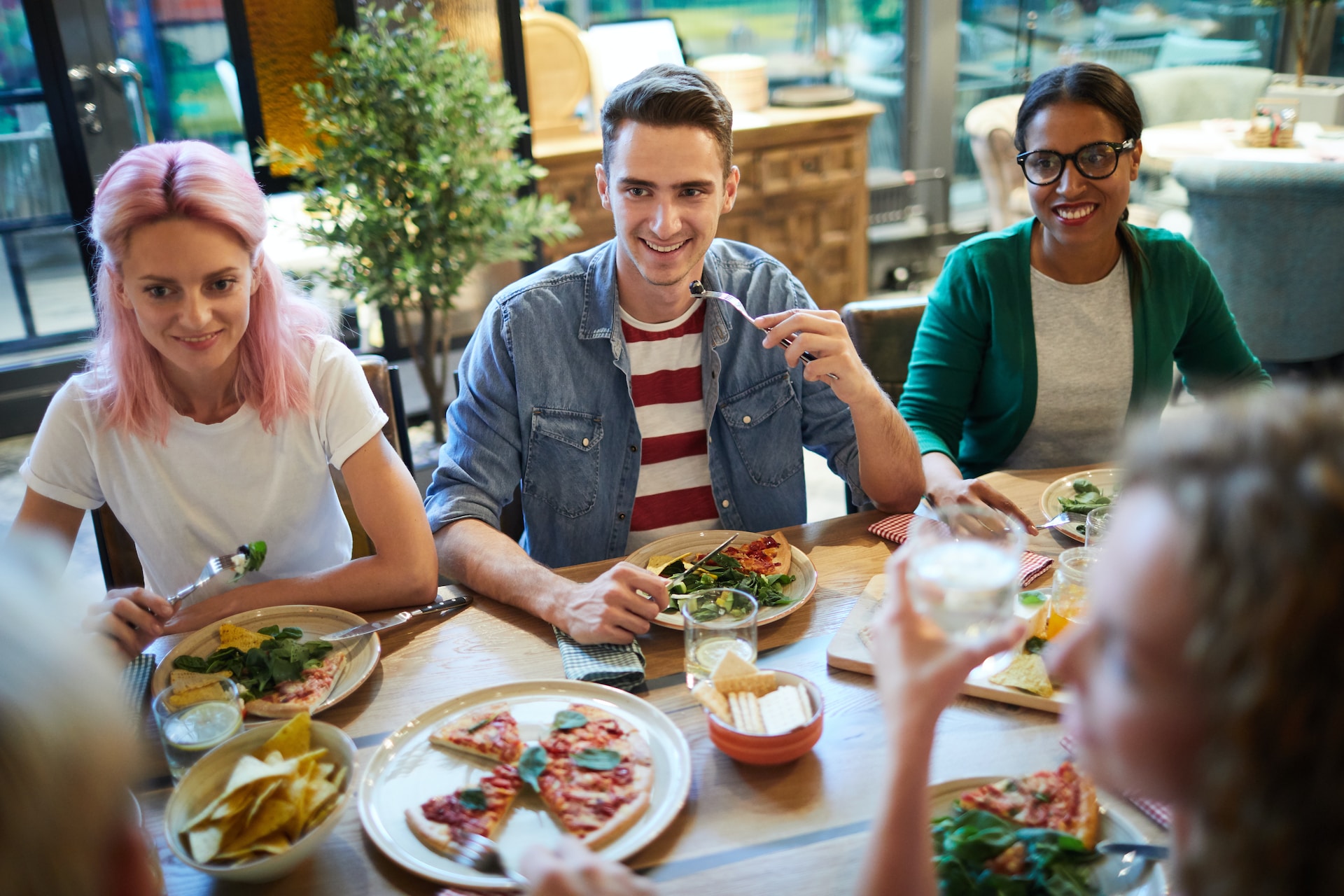 students sitting around a table eating healthy foods