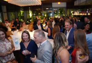room full of people standing around talking at JED's Florida Gala