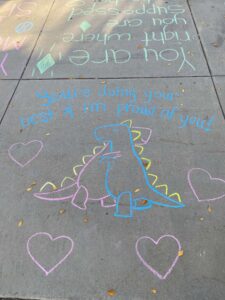 A chalk message that reads "You're doing your best and I'm proud of you!"