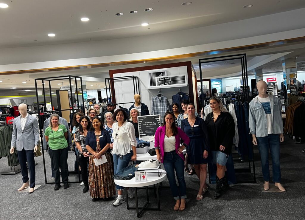 JED staffers standing in a Macy's store at an event.